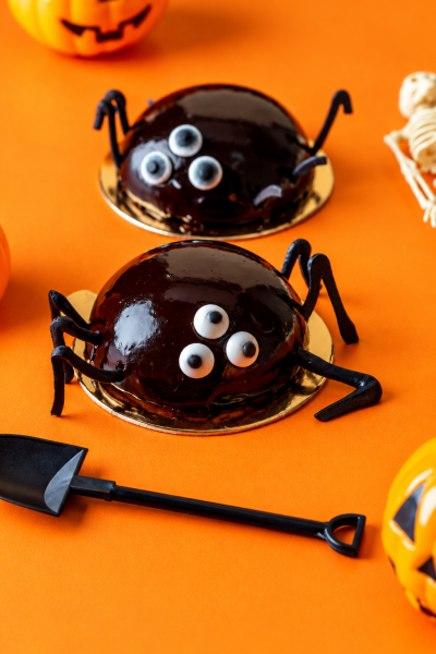 Glossy Chocolate Spider Desserts on Orange